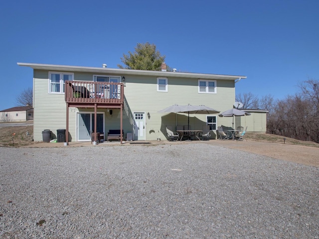 back of house featuring a patio area and a wooden deck