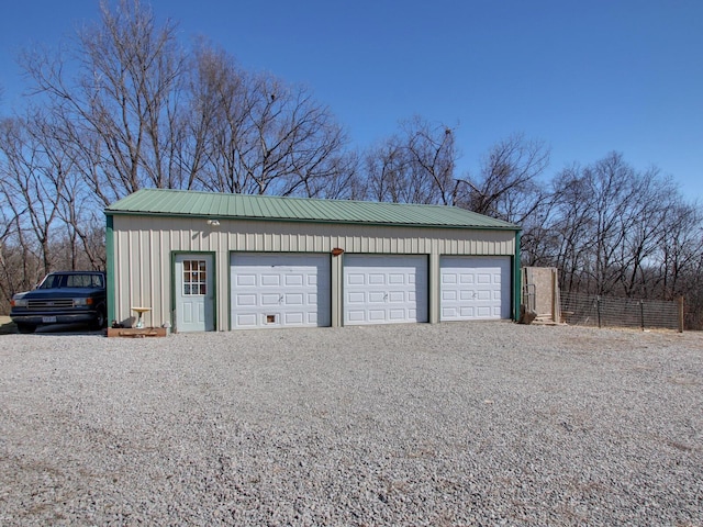 detached garage featuring fence