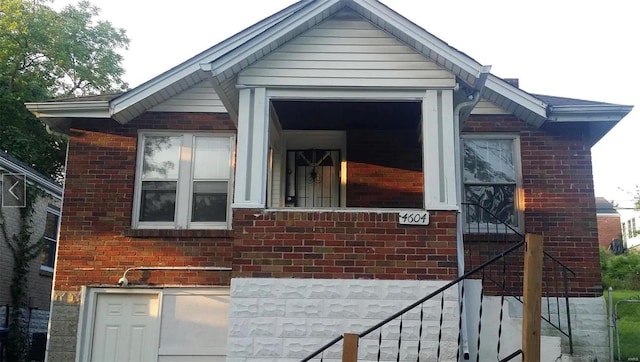 view of side of property featuring brick siding