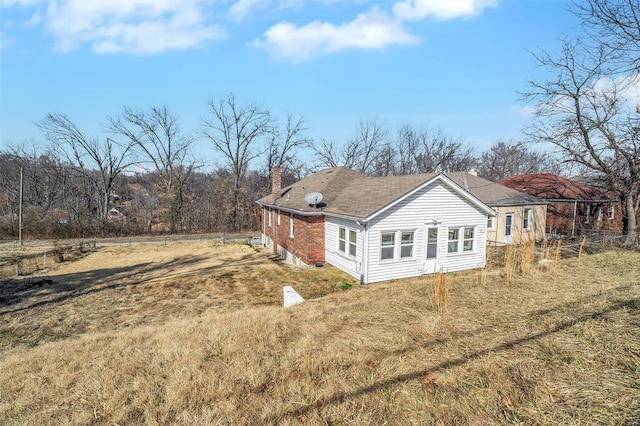 view of property exterior featuring a chimney