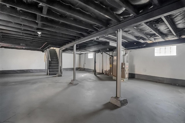 basement featuring stairway and water heater