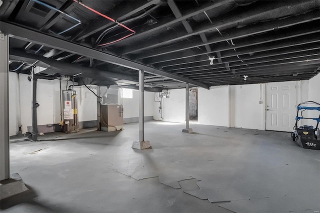 unfinished basement featuring water heater and heating unit