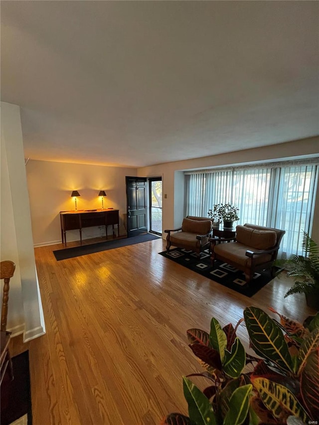 living room featuring baseboards and wood finished floors