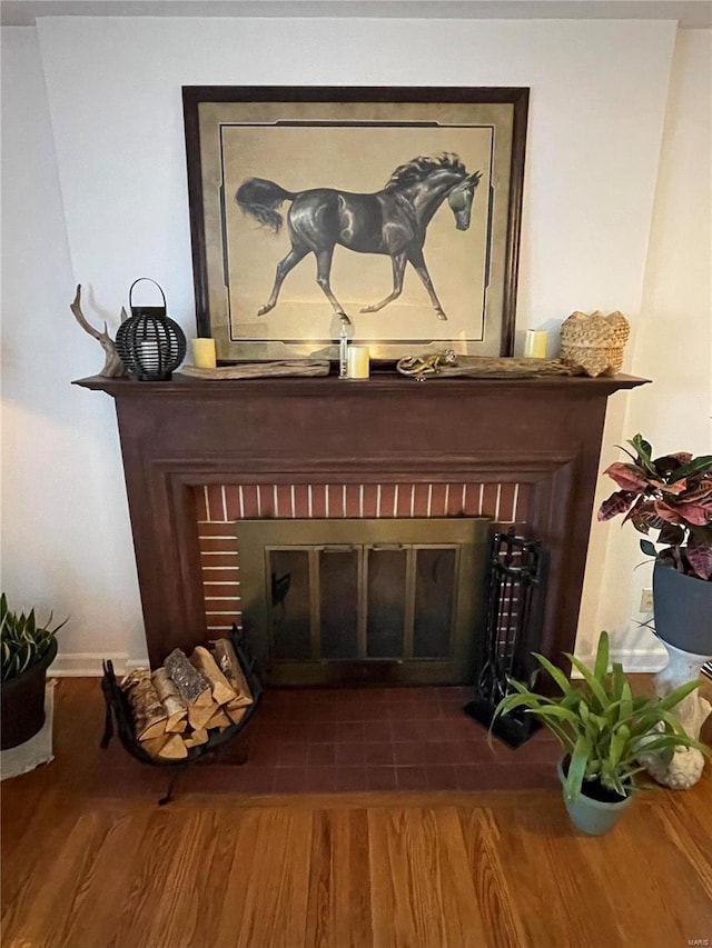 room details with wood finished floors and a fireplace