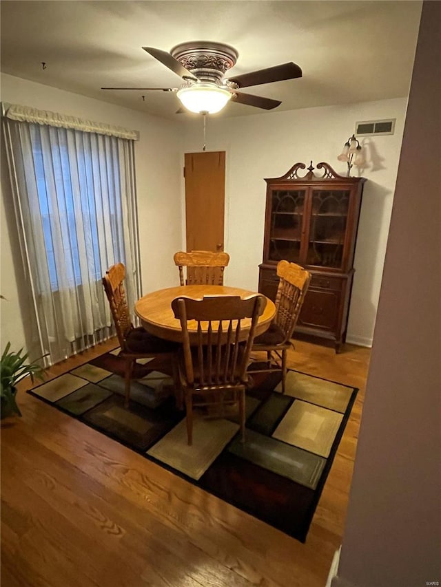 dining area featuring wood finished floors, visible vents, and ceiling fan