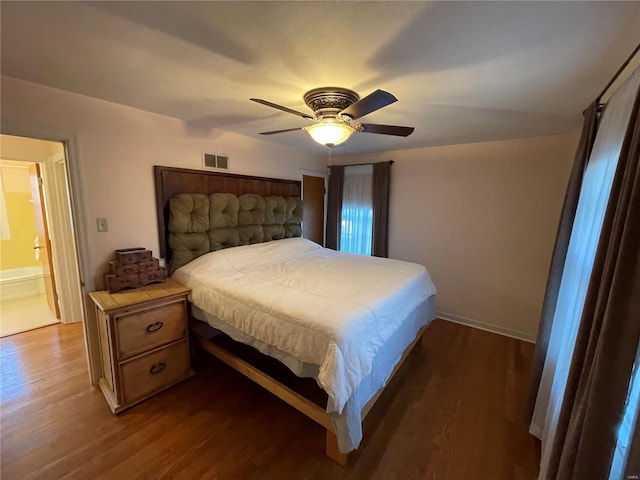 bedroom featuring dark wood finished floors, visible vents, and a ceiling fan