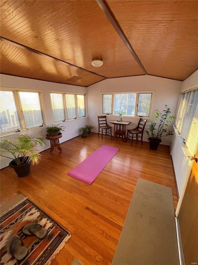 unfurnished sunroom featuring wood ceiling and vaulted ceiling