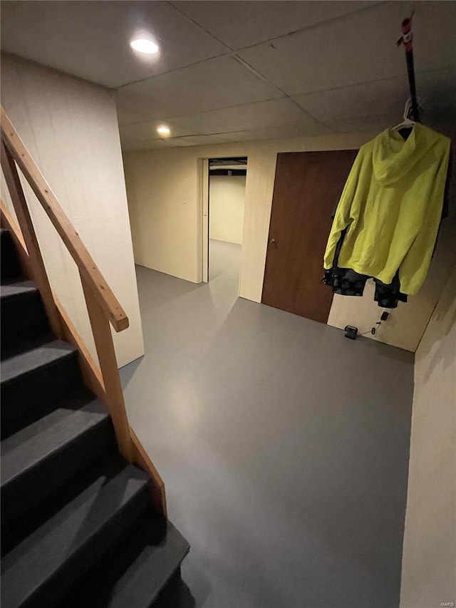 stairway with recessed lighting and concrete flooring