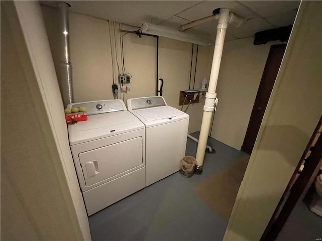 washroom featuring washing machine and clothes dryer and laundry area