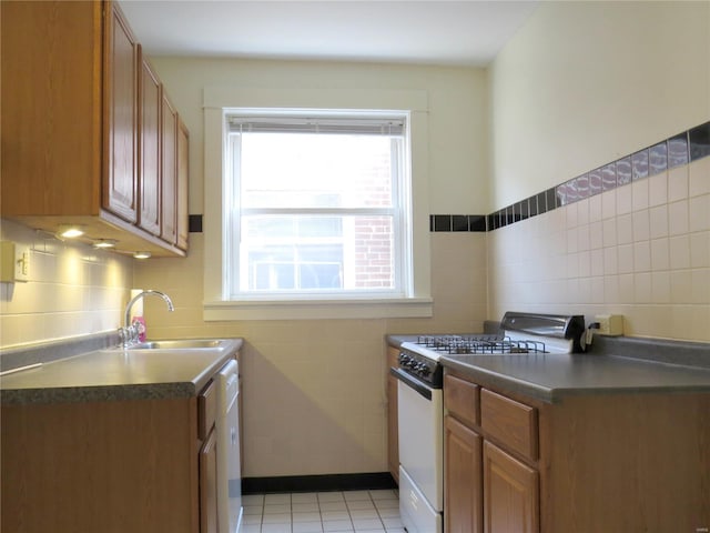 kitchen with a sink, white appliances, and dark countertops