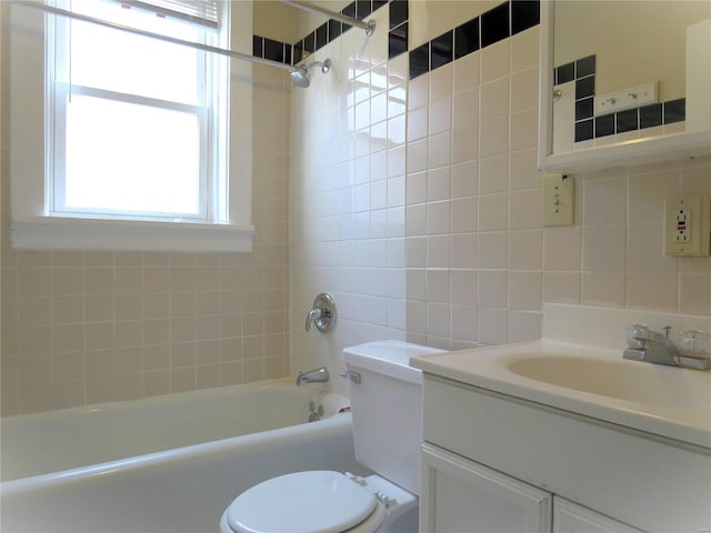 full bath featuring toilet, tile walls, decorative backsplash, bathtub / shower combination, and vanity