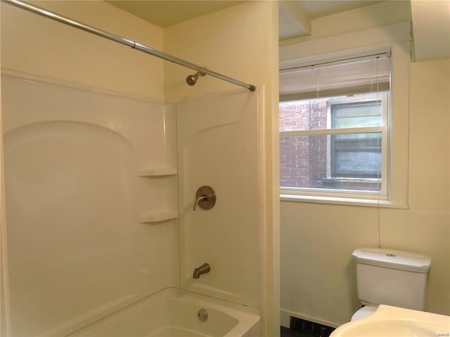 bathroom with toilet and washtub / shower combination