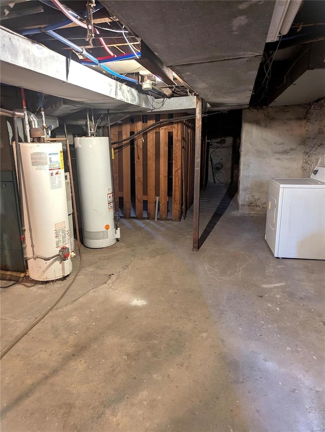 unfinished below grade area featuring gas water heater and washer / clothes dryer