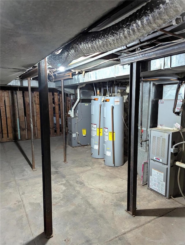 unfinished below grade area featuring heating unit, water heater, and electric water heater