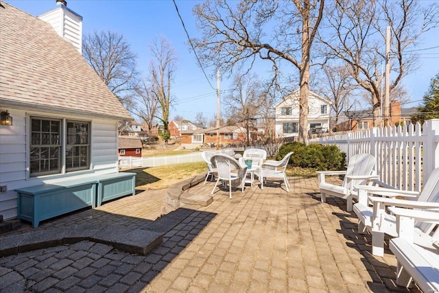 view of patio with outdoor dining area and fence