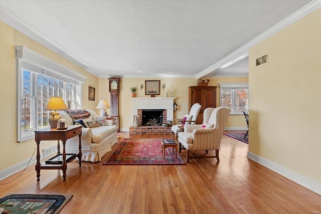 living area with ornamental molding, baseboards, and wood finished floors