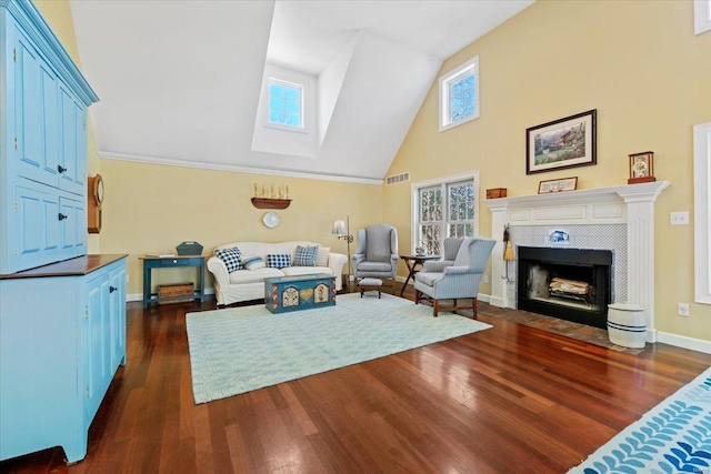 living area with visible vents, plenty of natural light, dark wood finished floors, and a tile fireplace