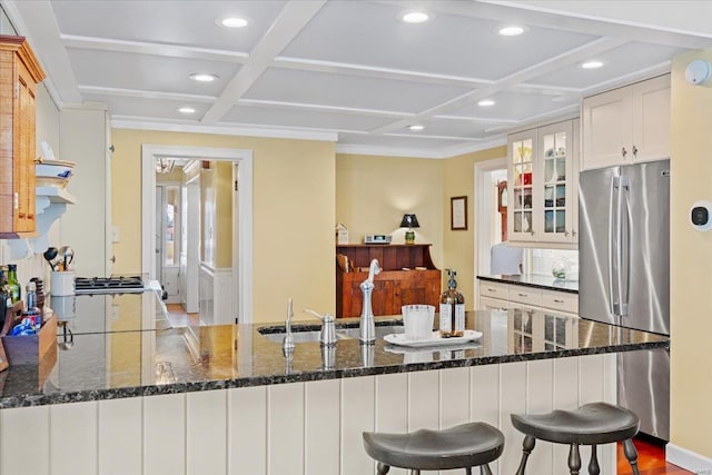 kitchen with recessed lighting, glass insert cabinets, coffered ceiling, and freestanding refrigerator