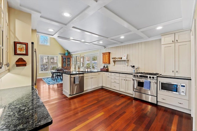 kitchen with a wealth of natural light, coffered ceiling, and stainless steel appliances