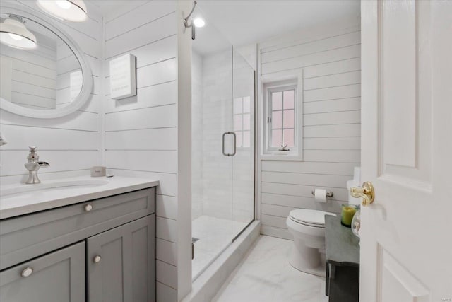 full bathroom with wooden walls, a shower stall, toilet, marble finish floor, and vanity