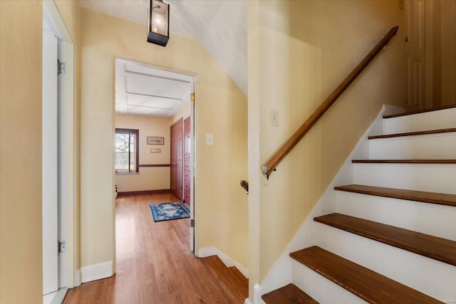 stairs featuring baseboards and wood finished floors