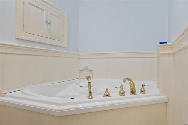 bathroom featuring wainscoting and a garden tub