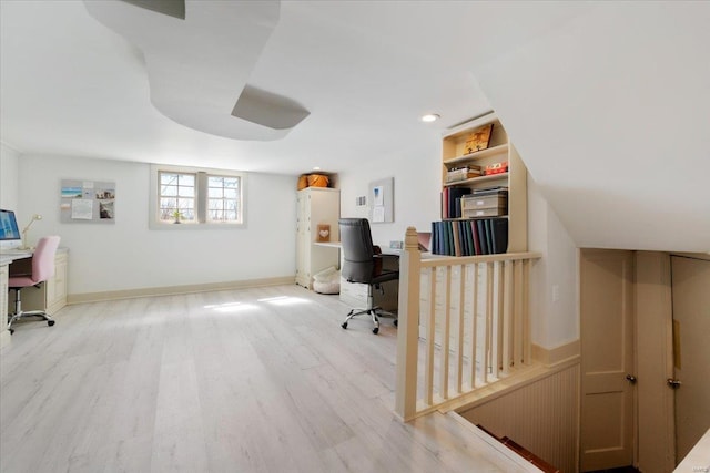 office space featuring baseboards and light wood finished floors