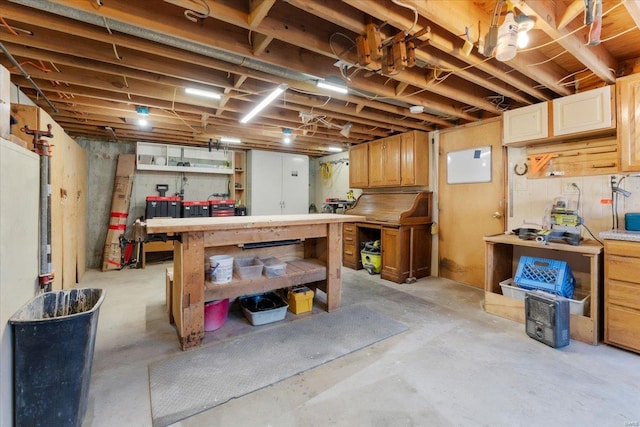 unfinished basement featuring a workshop area