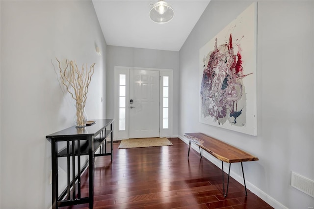 entryway with visible vents, baseboards, and wood finished floors