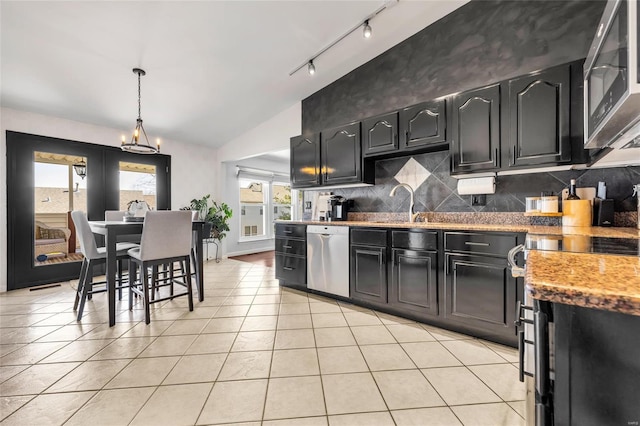 kitchen with decorative light fixtures, tasteful backsplash, stainless steel appliances, light tile patterned flooring, and vaulted ceiling