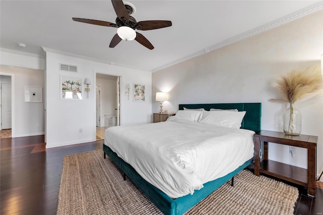 bedroom featuring visible vents, ornamental molding, baseboards, and wood finished floors