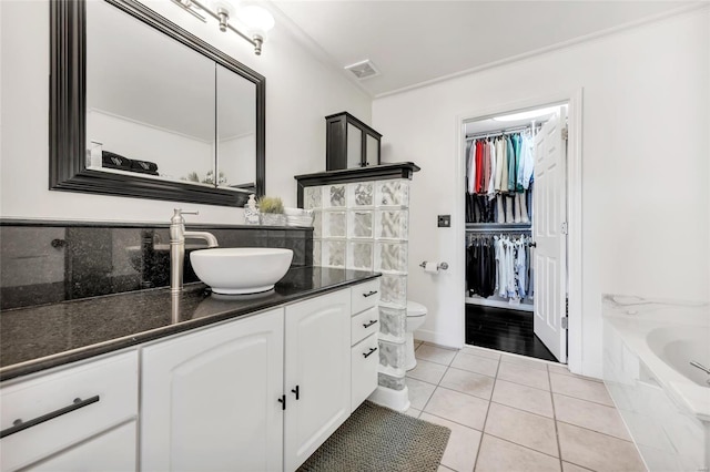 full bath featuring vanity, visible vents, crown molding, tile patterned floors, and toilet