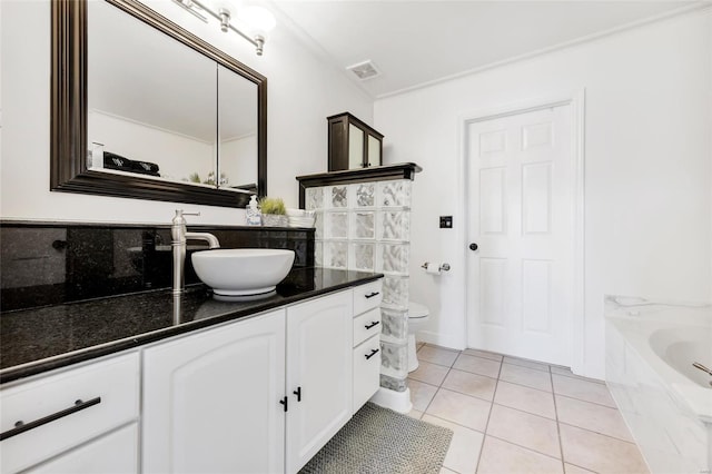 full bathroom featuring tile patterned flooring, visible vents, toilet, a bathtub, and vanity