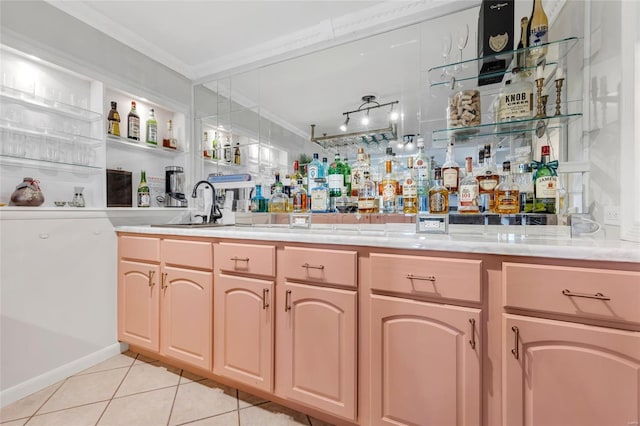 bar with light tile patterned floors, wet bar, and crown molding