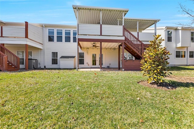 back of property featuring a yard, cooling unit, a sunroom, ceiling fan, and stairs