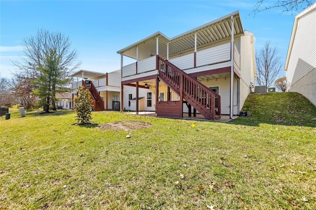 rear view of property with stairway, a yard, cooling unit, and a wooden deck