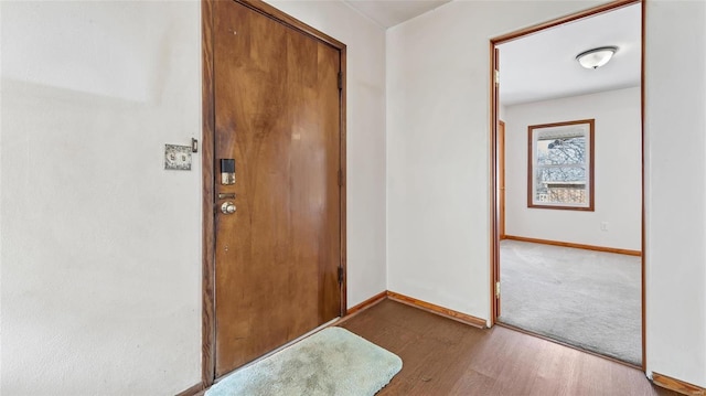 entryway featuring baseboards and wood finished floors