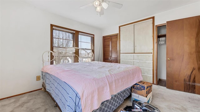 bedroom with light colored carpet, baseboards, and ceiling fan