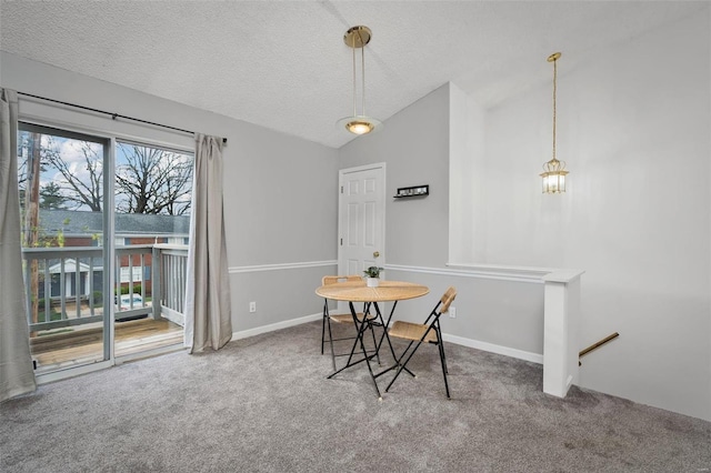 carpeted dining space with baseboards, a textured ceiling, and lofted ceiling