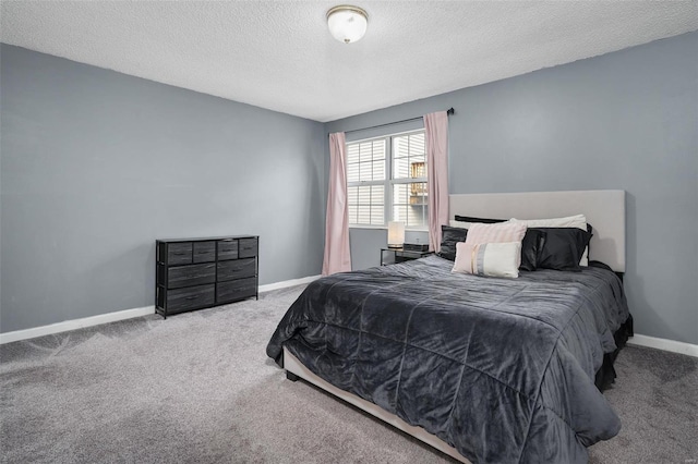 bedroom featuring carpet flooring, a textured ceiling, and baseboards