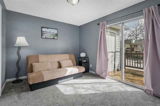 sitting room with baseboards and carpet floors