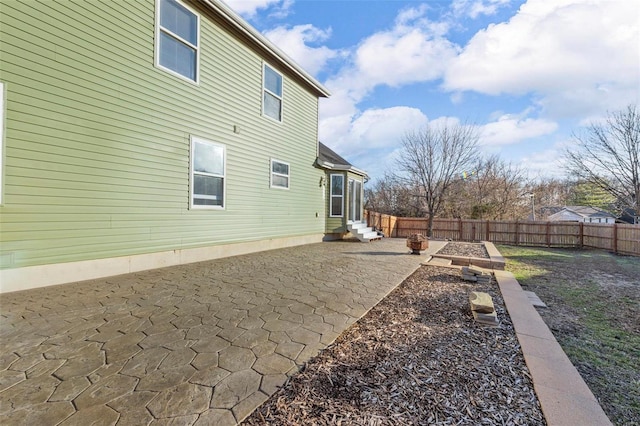 rear view of house featuring a patio, a fenced backyard, and entry steps