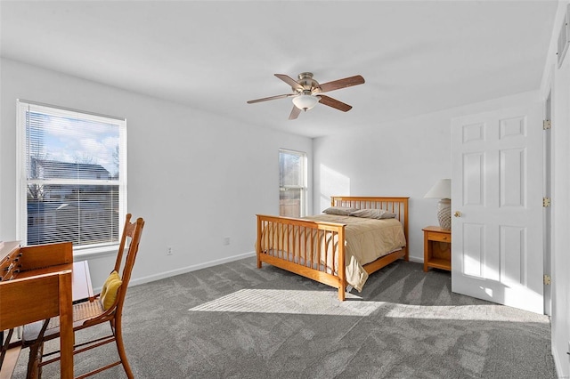 carpeted bedroom with a ceiling fan and baseboards