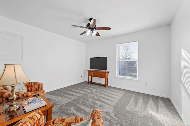 living area with baseboards, a ceiling fan, and carpet flooring