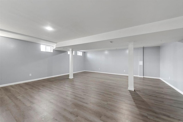 basement featuring wood finished floors and baseboards