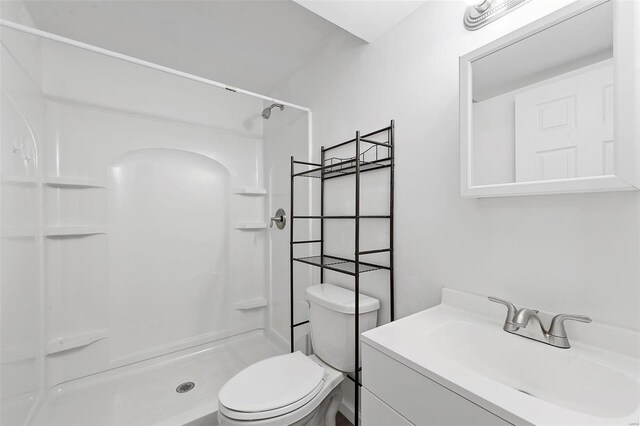 full bath with a shower stall, toilet, and vanity