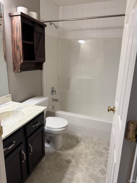 bathroom featuring toilet, vanity, and shower / bath combination