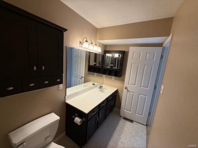 bathroom with toilet and vanity