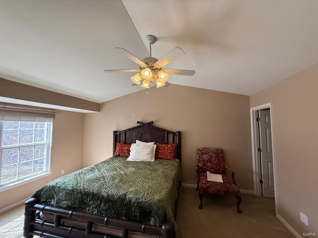 bedroom with baseboards, ceiling fan, carpet flooring, and vaulted ceiling