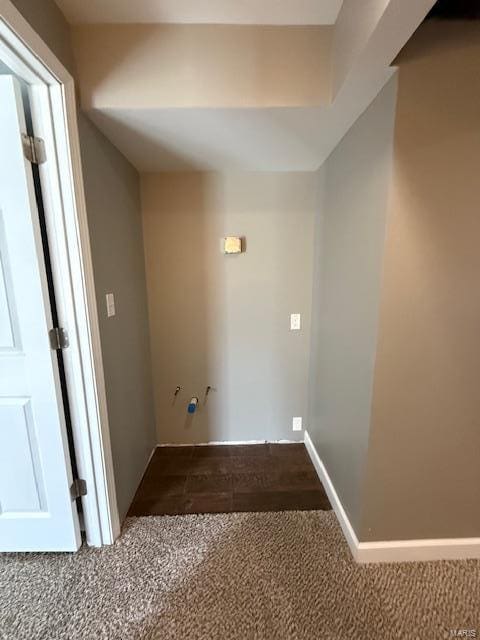 laundry room featuring baseboards and carpet